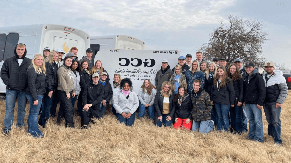 group of college students standing & kneeling outdoors